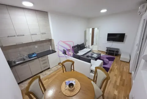 Open-plan living room with dining area and kitchen. - image 8