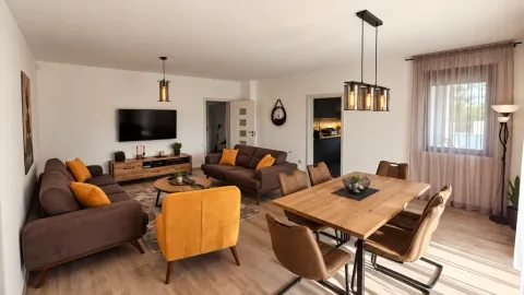 Spacious living room with a dining area and modern furniture. - image 13