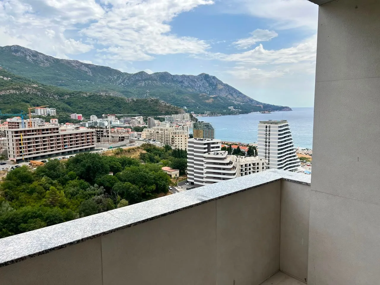View of the sea and city from a spacious balcony.