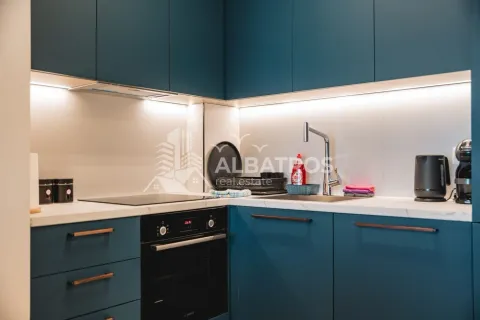 Modern kitchen with blue cabinets and a built-in oven. - image 12