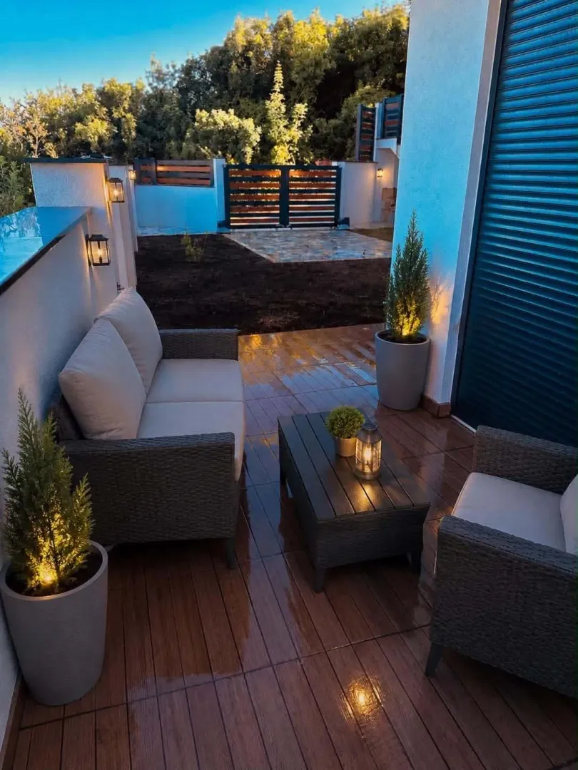 Furnished terrace with patio furniture and a view of the yard.