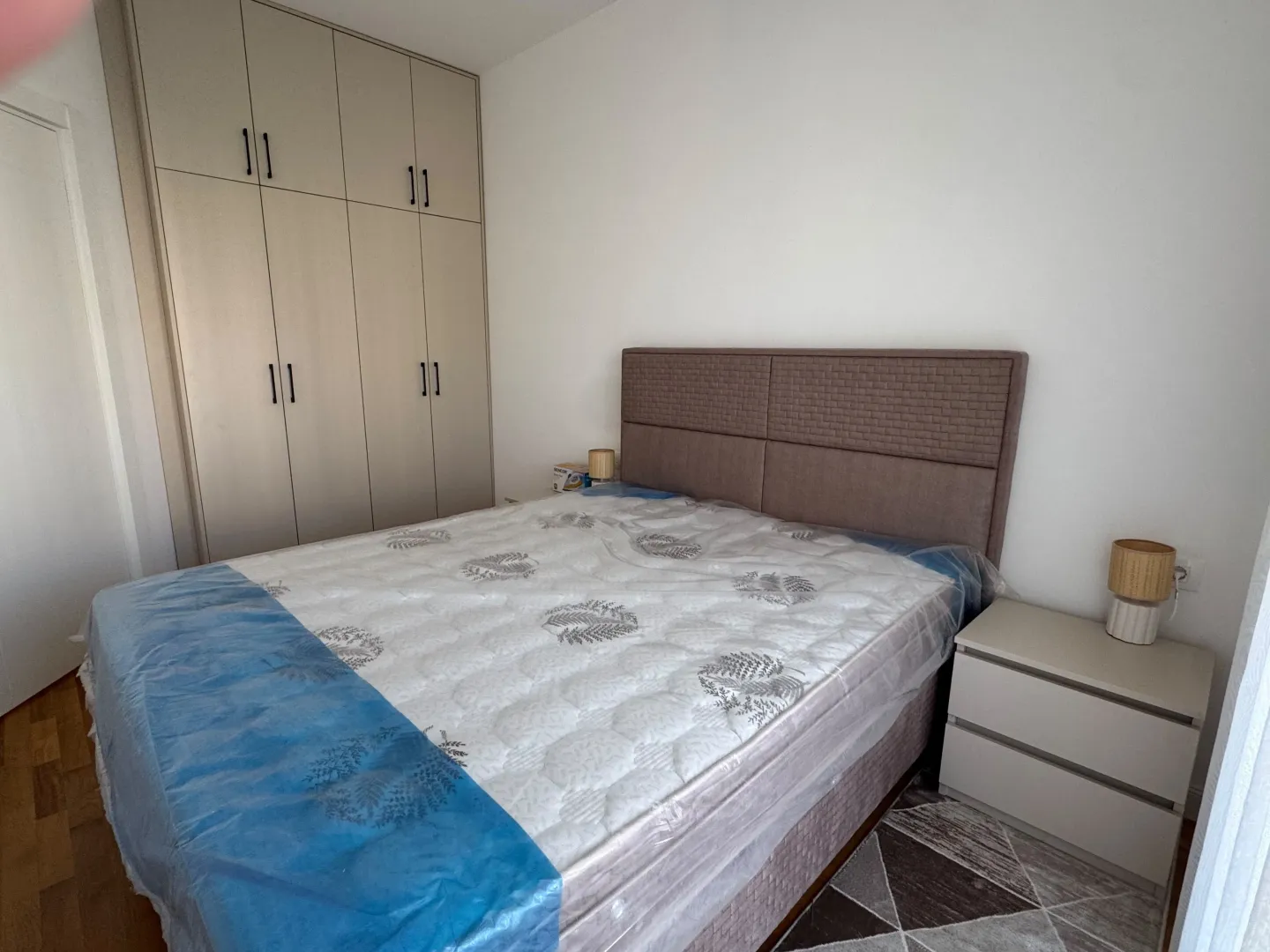 Furnished bedroom with a double bed, wardrobe, and nightstands.