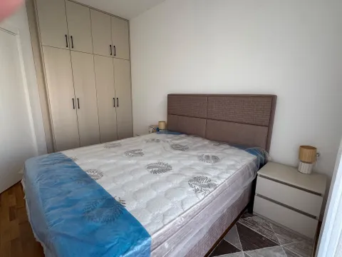 Furnished bedroom with a double bed, wardrobe, and nightstands. - image 9