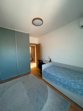 Smaller bedroom with a bed, wardrobe, and desk. - image 5