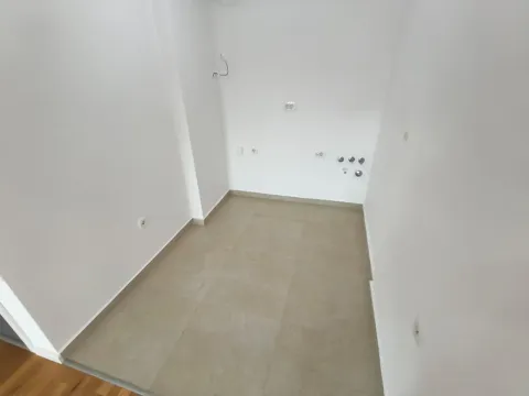 Prazna prostorija sa keramičkim pločicama i instalacijama na zidu. - image 3