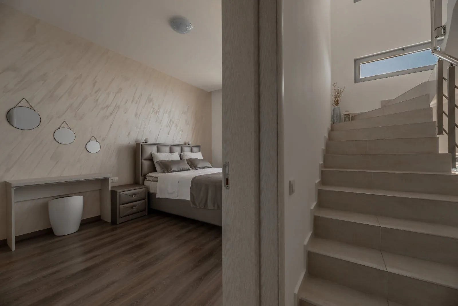 View from the hallway towards the bedroom and stairs.