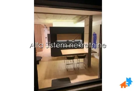 Modern kitchen with a breakfast bar and dining table. - image 6