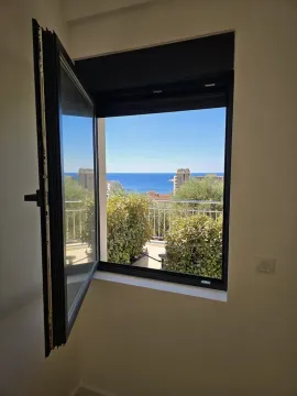 Sea view through an open room window. - image 6