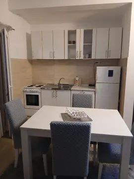 Kuhinja sa trpezarijskim stolom i bijelom tehnikom. - image 3