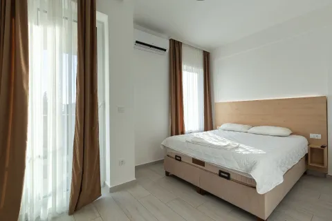 Svijetla spavaća soba sa bračnim krevetom, drvenim uzglavljem i izlazom na terasu. - image 34