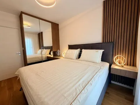 Modern bedroom with a double bed, large mirrored wardrobe, and wooden wall panels. - image 9