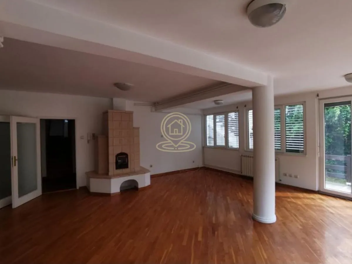 Spacious living room with a fireplace and hardwood flooring.