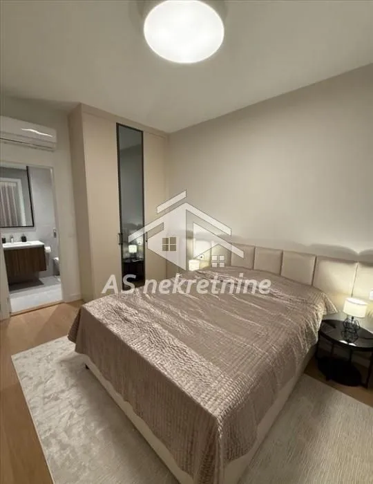 Furnished bedroom with a double bed, wardrobe, and en-suite bathroom.