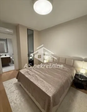 Furnished bedroom with a double bed, wardrobe, and en-suite bathroom. - image 9