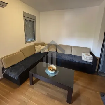 Living room with a corner sofa and coffee table. - image 2
