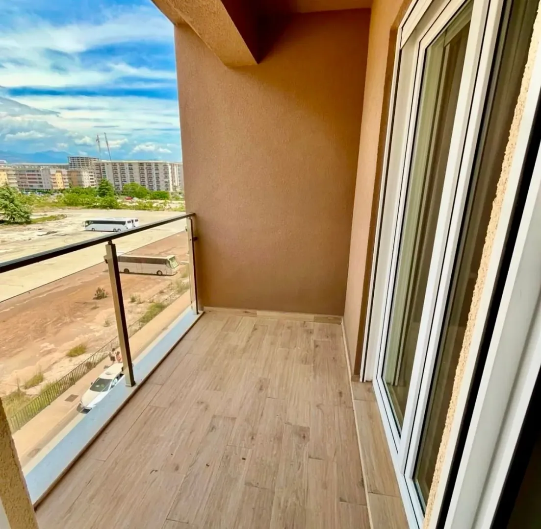 Unfurnished balcony with a glass railing and a city view.