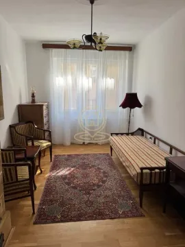 Furnished bedroom with a bed, armchairs, and a rug. - image 13