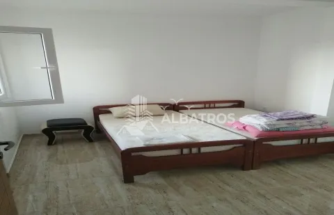 Bedroom with two wooden beds and a small window. - image 4