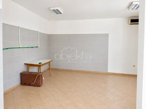 Empty room with tiles on the lower part of the walls and installations. - image 5