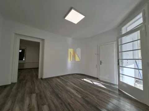 Empty room with white walls, wooden flooring, and access to the terrace. - image 2