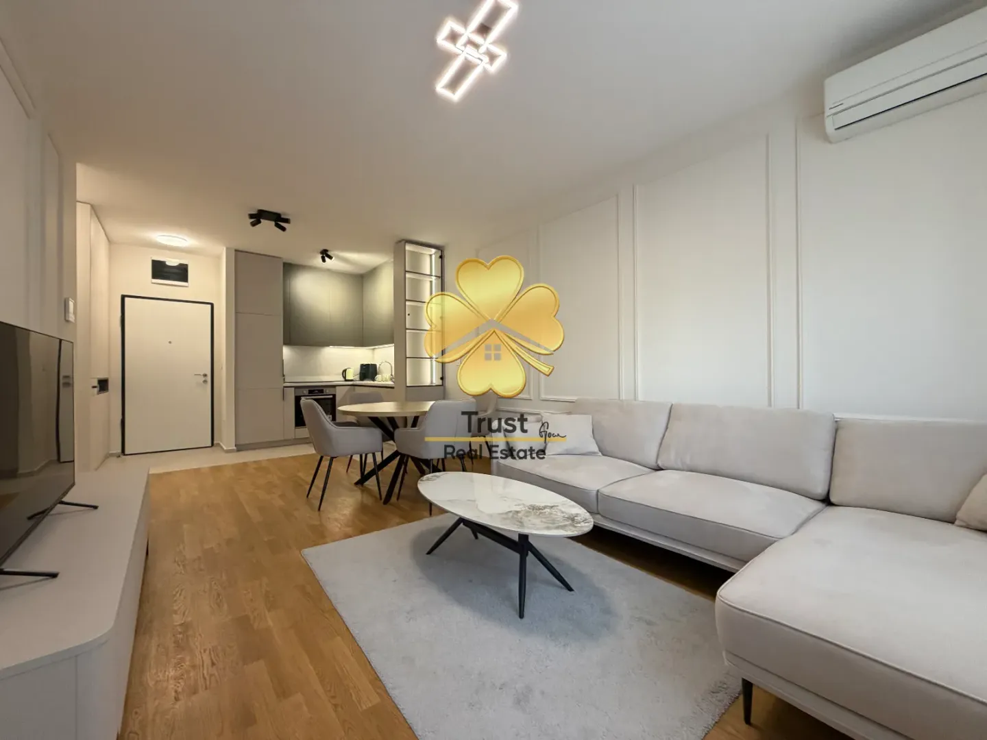 Modern living room connected to the dining area and kitchen.