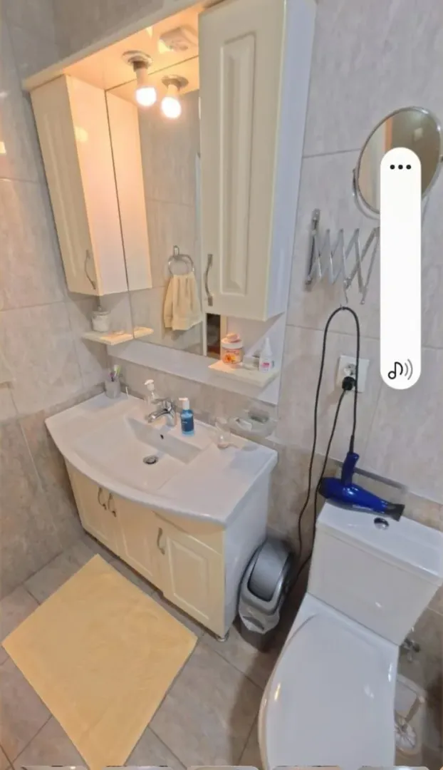 Smaller bathroom with a sink, cabinet, mirror, and toilet bowl.