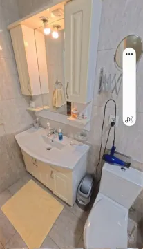 Smaller bathroom with a sink, cabinet, mirror, and toilet bowl. - image 10