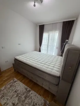 Bedroom with a double bed and a window with curtains. - image 5