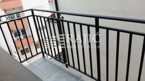 View from the balcony overlooking surrounding buildings. - image 7