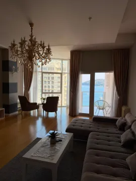 Living room with sofa, large windows and a sea view. - image 17