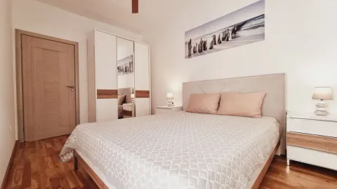 Furnished bedroom with a double bed, wardrobe, and nightstands. - image 6