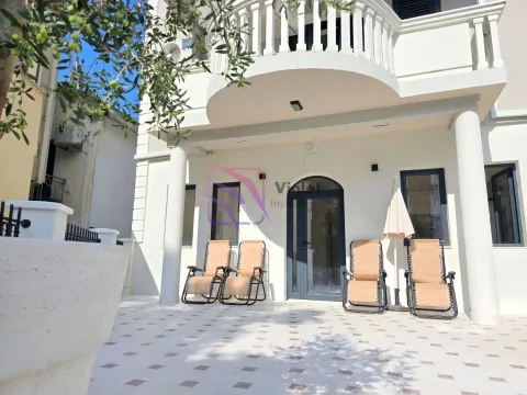 Tiled courtyard with sun loungers in front of the building entrance. - image 3
