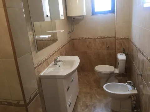 A simple bathroom featuring a sink, bidet, and toilet. - image 7