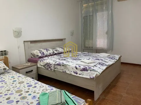Furnished bedroom with a double bed and a window. - image 10
