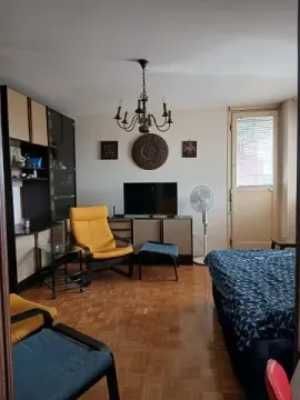 Living room with seating furniture, television, and parquet flooring. - image 7