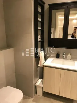 Modern bathroom with a sink, mirror, and toilet. - image 20