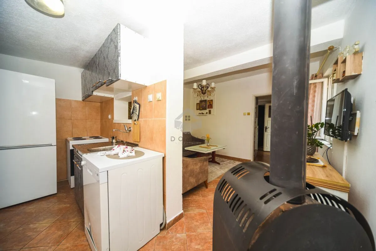 Smaller kitchen with appliances and a view of the living room.