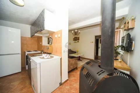 Smaller kitchen with appliances and a view of the living room. - image 4