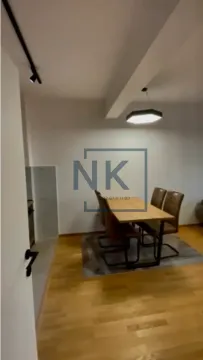 Dining area with a wooden table and chairs. - image 4