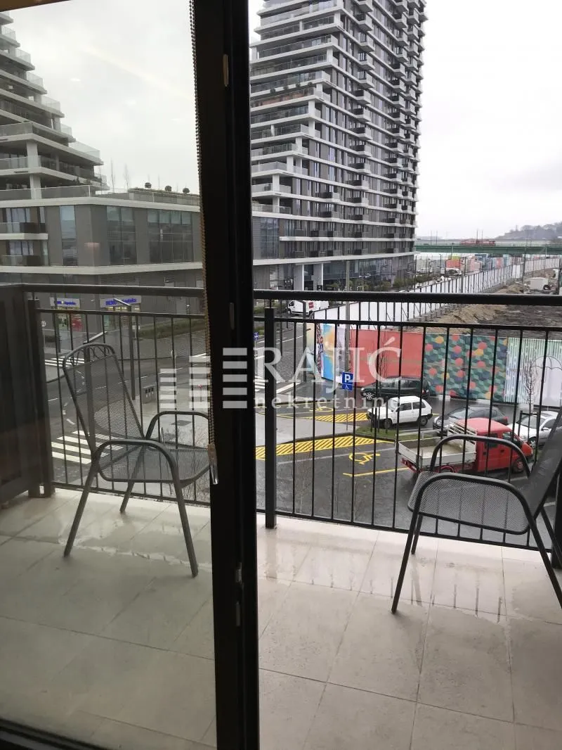 View from the balcony overlooking the urban surroundings and nearby buildings.