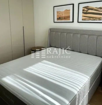 Modern bedroom with a double bed, wardrobe, and wall art. - image 6