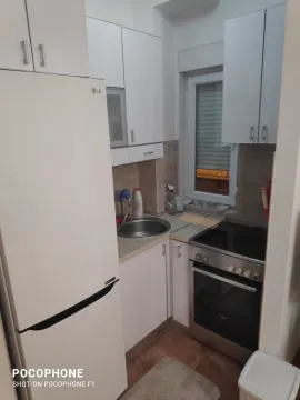 A small kitchen featuring white cabinetry and standard appliances. - image 3