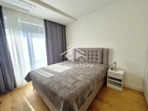 Furnished bedroom with a double bed, bedside table, and access to the terrace. - image 7