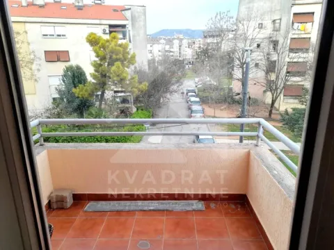 Manji popločani balkon sa ogradom i pogledom na naselje i ulicu. - image 10
