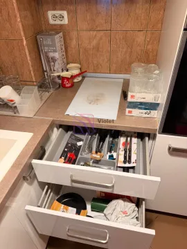 Part of the kitchen with a countertop and open drawers. - image 6