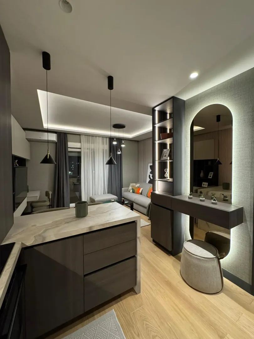 Modern living room with a kitchen and dining area.
