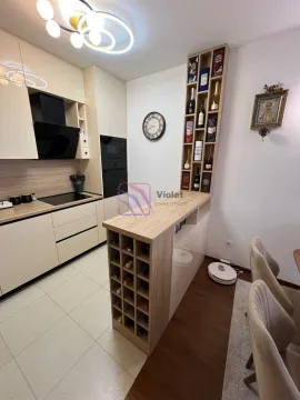 Modern kitchen with a wine bar and built-in appliances. - image 4