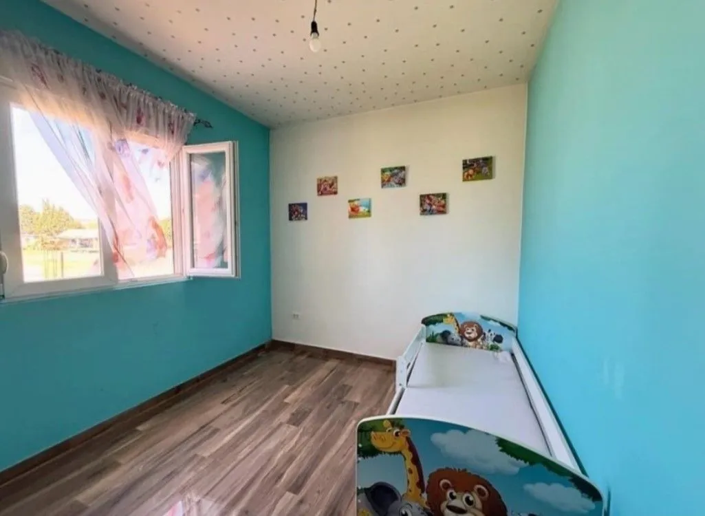Children's bedroom with a bed and blue-and-white walls.