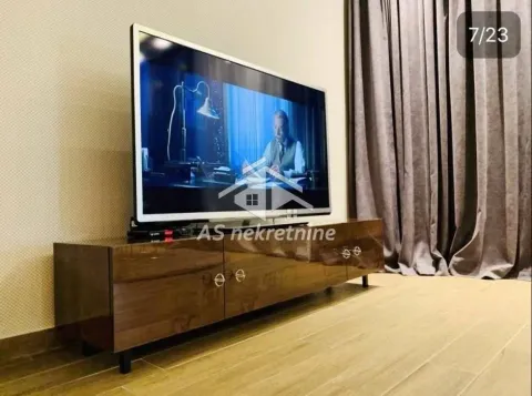 View of the TV cabinet with a television in the living room. - image 3