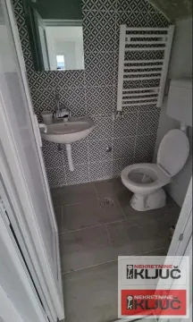 Small bathroom with a sink, toilet and decorative tiles. - image 6